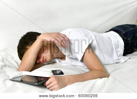 Young Man Sleeps With Tablet Computer