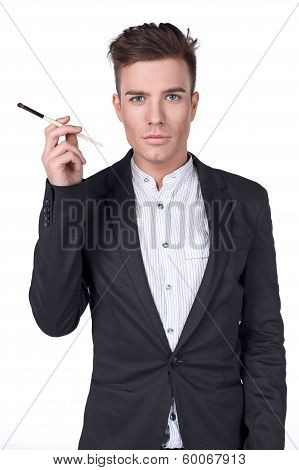 Stylish young handsome man in a suit with a brush.