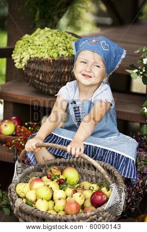 Happy Little Girl Holding A Basket With Pears