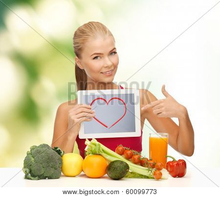 fitness, diet, technology, health and food concept - sporty woman with fruits and vegetables pointing at tablet pc