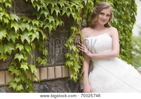 Beautiful bride with stylish make-up in white dress