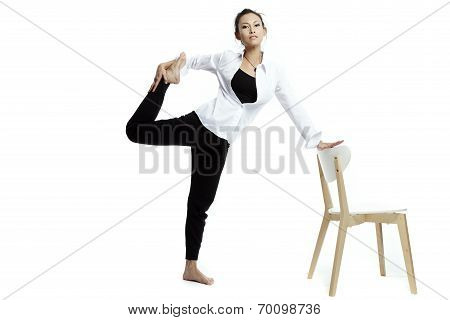 Young Beautiful Yoga Posing On A White Studio Background.