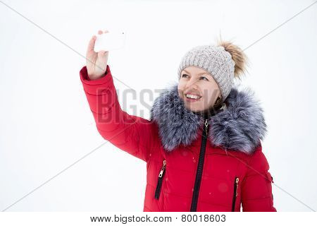 Happy Smiling Female In Red Winter Jacket Taking Selfie, Self-portrait With Smartphone, Outdoors, Ag