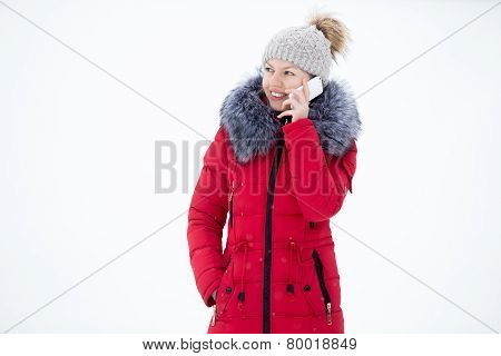 Happy Smiling Female In Red Winter Jacket Talks On Mobile Phone, Outdoors, Against The Snow