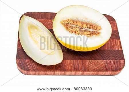 Honeydew melon on cutting board isolated over white background
