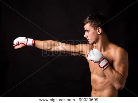 Portrait of boxer hitting in gloves.