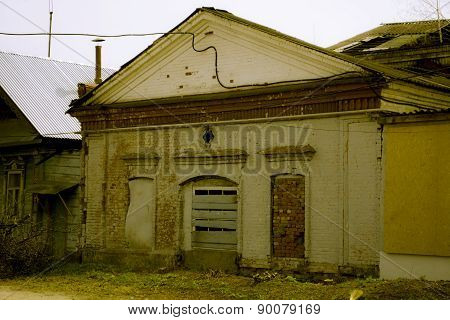 Facade of the destroyed building with boarded up windows a bakery