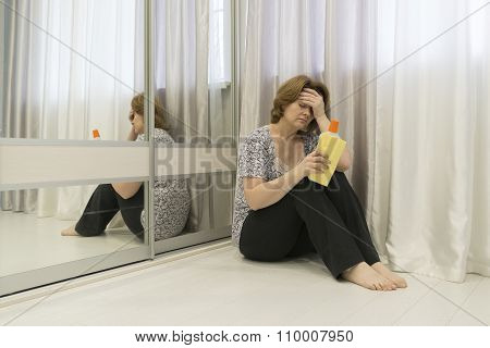 Tired of cleaning housewife sitting on  floor