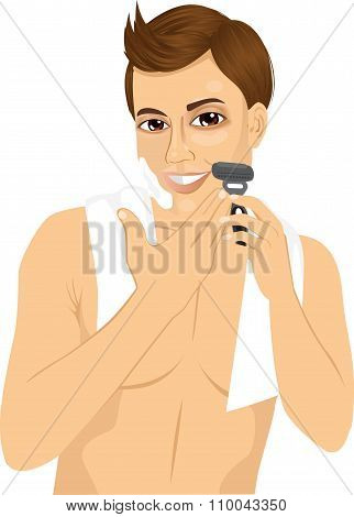 young man shaving with razor