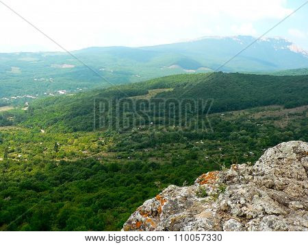 Rock And Forest In Mountains And Cloudy Sky