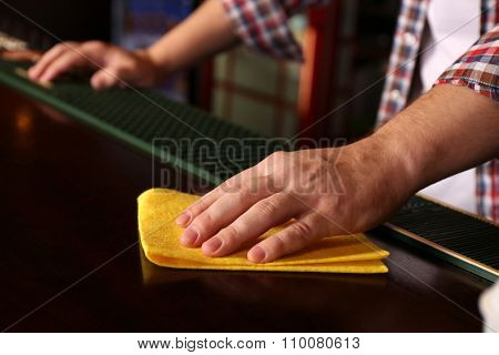 Bartender wiping down bar counter