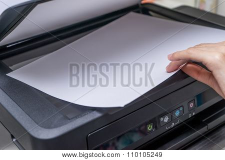 Close up Woman's hand with working copier printer