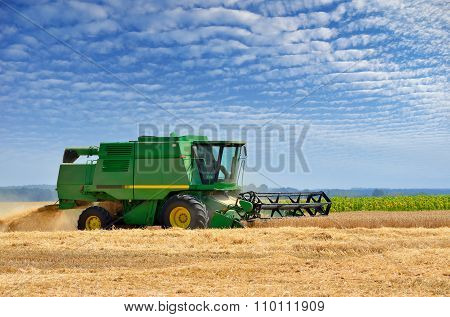 Agricultural Machinery Harvests Of Cereal Crops In The Field