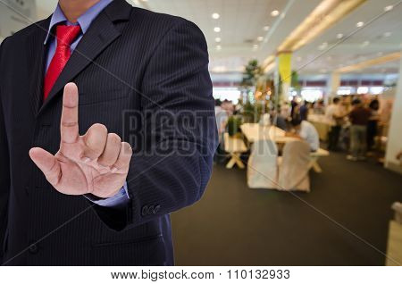 business man touch virtual screen with blurry event background