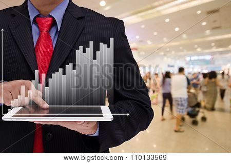 Business Man Holding Tablet With Business Graph Virtual Screen