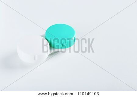 Contact Lenses In Container With Solution On White Background