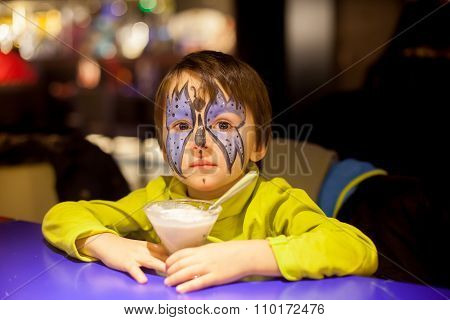 Little Boy With Painted Face As Butterfly, Eating Ice Cream