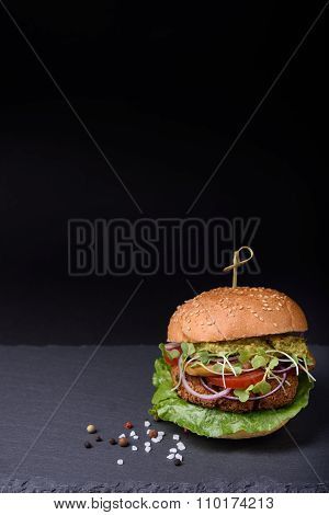 Homemade hamburger with grilled beef cutlet served with pepper and sea salt.