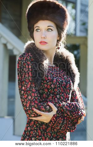 Looking Away Russian Beauty In Traditional Fur Cossack Hat And Crossed Arms