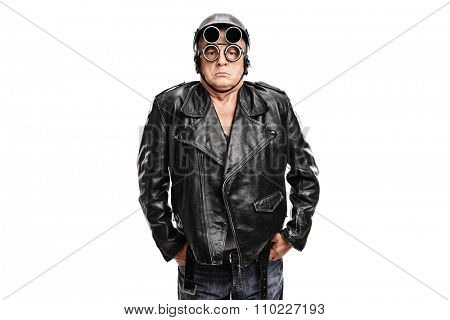 Grumpy mature motorcyclist posing in a black leather jacket with a helmet and goggles isolated on white background