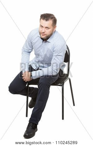 man sitting on chair. Isolated white background. Body language. gesture of readiness for action. sta