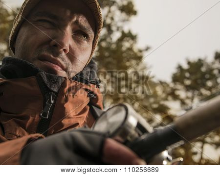 Mature man fishing  on the wild river