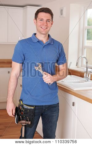 Plumber Fixing Kitchen Tap With Adjustable Wrench