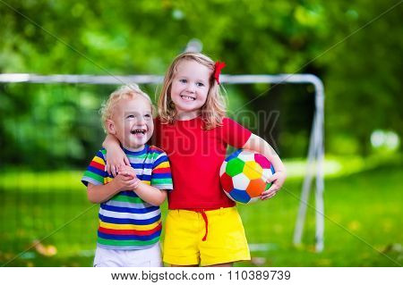 Kids Playing Football In A Park