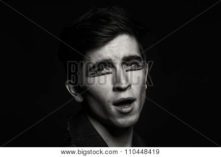 Young, handsome male actor. Actor in theatrical makeup. Emotional game male actor.