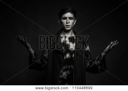 Young, handsome male actor. Actor in theatrical makeup. Emotional game male actor.
