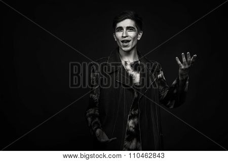 Young, handsome male actor. Actor in theatrical makeup. Emotional game male actor.
