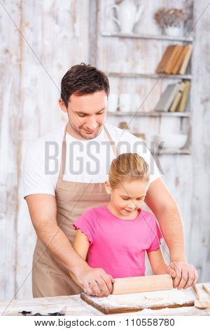 Happy father and daughter baking together