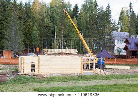 Crane Lifts Planks To Build A House