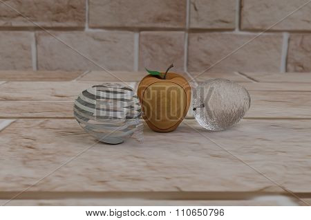 Three apples of glass and wood, on the track of  stone. The background is blurred