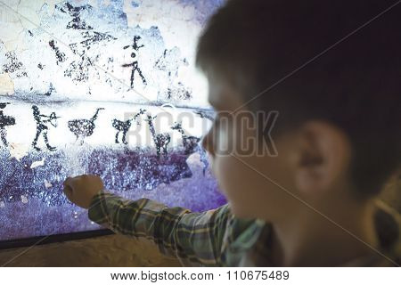 Child Looks At Aancient Mural