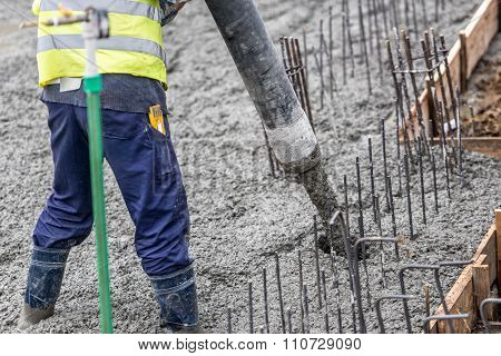 Contruction Worker Pouring Concrete, Directing The Pump Tube