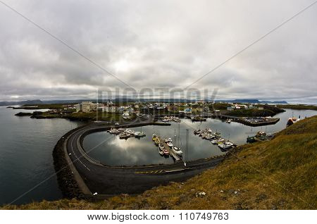 Stykkisholmur harbor in west Icelandic fjord with cityscape in background