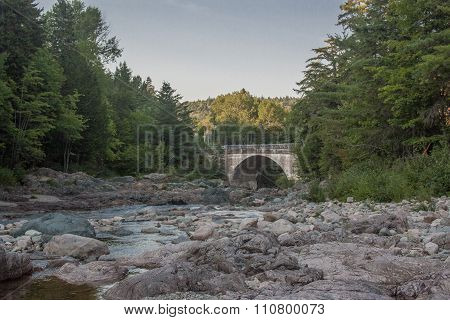 stone bridge over rocky riverbed