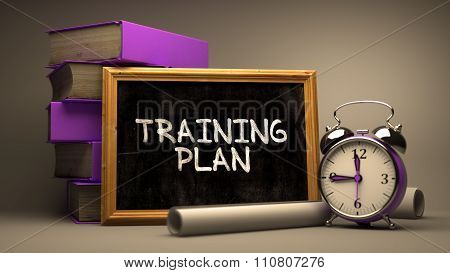 Training Plan Handwritten by white Chalk on a Blackboard.