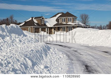 A freshly plowed road in America suburbia after a snow storm.