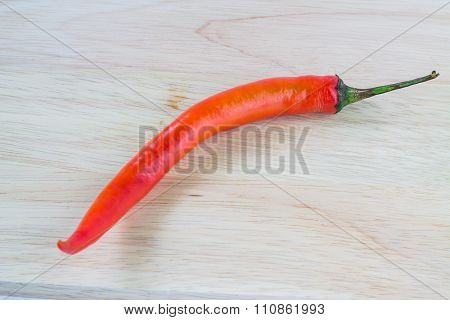 Young red pepper paste on a wooden cutting board brown.