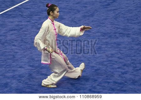 JAKARTA, INDONESIA: NOVEMBER 14, 2015: Naoko Ichikizaki from Japan performs the movements in the women's Taijiquan event at the 13th World Wushu Championship 2015 held at Istora Senayan, Jakarta.