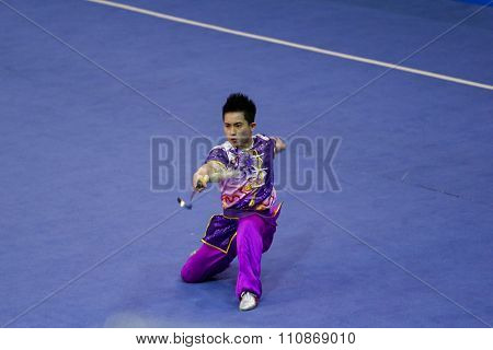 JAKARTA, INDONESIA: NOVEMBER 14, 2015: Wong Weng Son from Malaysia performs the movements in the men's Jianshu (swords) event at the 13th World Wushu Championship 2015 at Istoran Senayan.