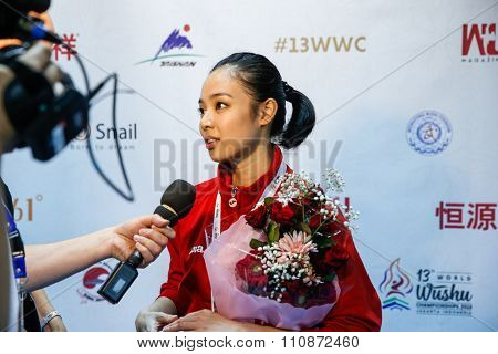 JAKARTA, INDONESIA - NOVEMBER 14, 2015: Lindswell Kwok from Indonesia speaks to Wushu TV after winning the gold in the women's Taijiquan event in the 13th World Wushu Championship 2015.
