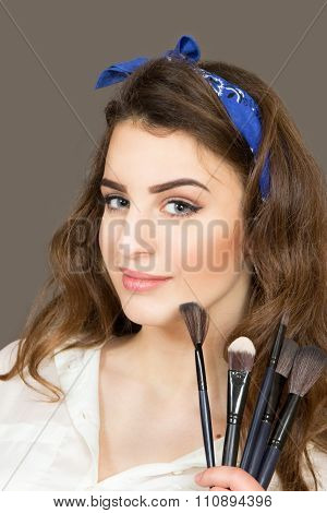 Portrait - A Face Of The Beautiful Young Girl With Brushes For A Make-up.