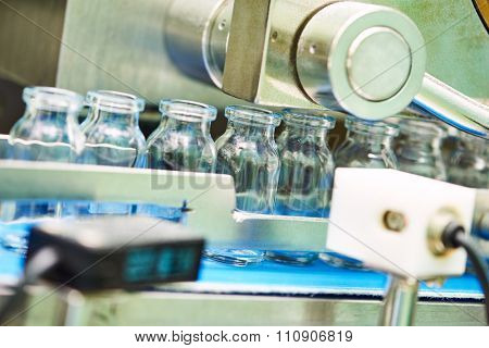 pharmaceutical industry. Production line machine conveyor with glass bottles ampoules at factory