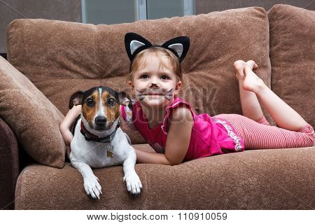 Little Girl With Cat Face Painting Embrace Her Dog