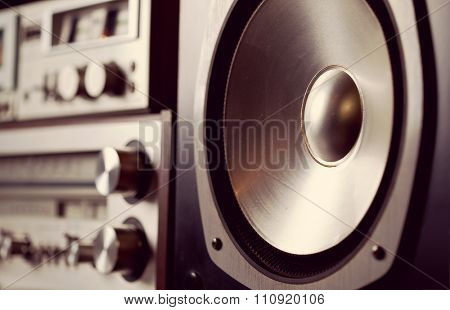 Vintage audio stereo rack with cassette tape deck receiver and speaker, angled view