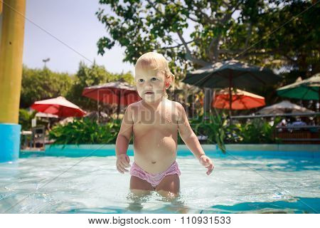 Closeup Small Blonde Girl Smiles Plays In Shallow Swimming Pool