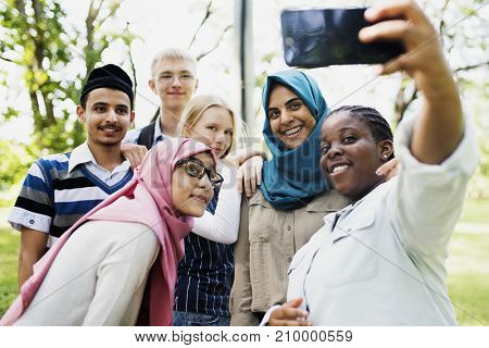 Group of students using mobile phone